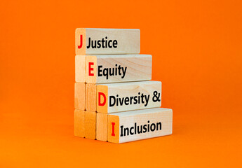 Naklejka premium Justice equity diversity inclusion symbol. Concept words JEDI Justice Equity Diversity Inclusion on blocks. Beautiful orange background. Business justice equity diversity inclusion concept. Copy space