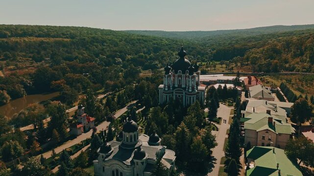 Curchi Monastery. A stunning aerial shot captures a beautiful church nestled in a vibrant green valley, showcasing natures pure serenity