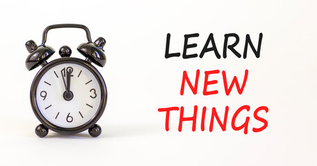 Learn new things symbol. Concept words Learn new things on beautiful white paper. Beautiful white background. Black alarm clock. Business motivational learn new things concept. Copy space.