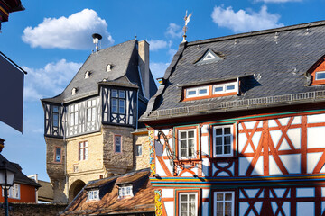 Obraz premium Picturesque view of colorful half-timbered houses and a medieval Castle in the historic town of Idstein, Germany