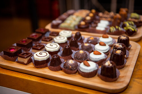 Delightful assortment of artisan chocolates displayed on a vibrant plate at an event dedicated to sweet treats during a festive gathering