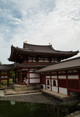 Vertical photograph with its reflection in the water of the Byōdō-in, and its garden, is a Buddhist temple located in the city of Uji, Kyoto, Japan. The image appears on the 10 yen coin. World Heritag