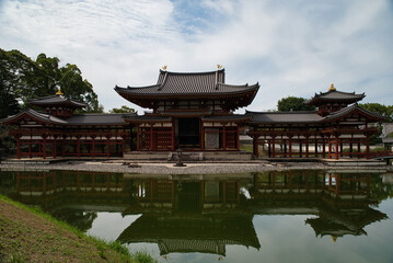Fototapeta premium View with its reflection in the water of the Byōdō-in, and its garden, is a Buddhist temple located in the city of Uji, Kyoto, Japan. The image appears on the 10 yen coin. World Heritage Site. 