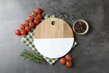 Cutting board with tomatoes and spices on grey table, flat lay