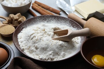 Ingredients for dough and rolling pin on table, closeup