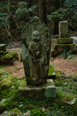 Stone statue of Jizō Bodhisattva, a common type of Japanese religious figure often found in temples and cemeteries. Okunoin Temple, Koyasan, Wakayama Prefecture, Japan.