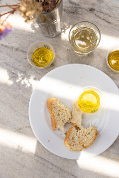 Olive oil tasting with bread on a sunny afternoon in Paros, Greece.