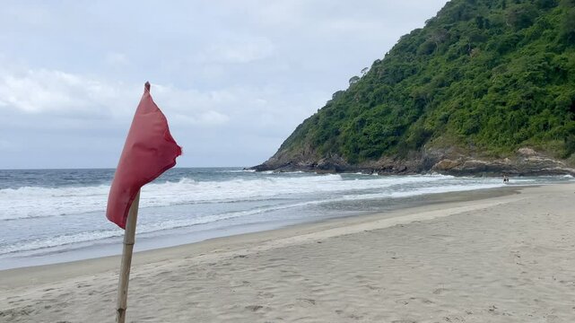 Red flag at Playa Brava in Tayrona National Park, Colombia.