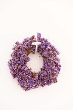 Dried lavender flowers in a wreath hanging outside a whitewashed wall in small Greek village in Paros, Greece.
