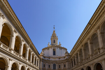 The 17th century Baroque church and courtyard Chiesa di Sant Ivo alla Sapienza (University of Rome) by Francesco Borromini against a deep blue sky in Rome, Italy 