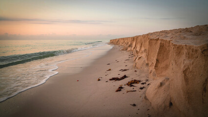 Beach coastline cliff of sand made by ocean waves. 
