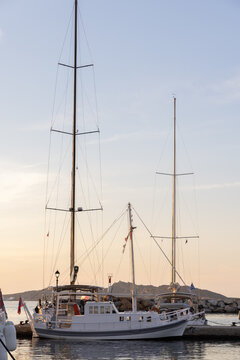 Yacht in the marina during sunset at a Greek island. 