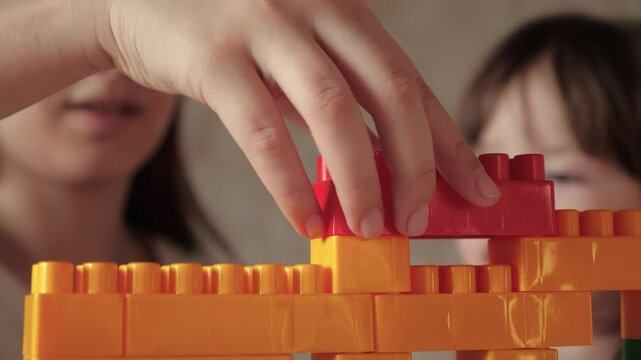 happy family. little kid child engaged lesson with psychologist. kid play game constructor. children development motor skills hand finger. colorful game children. educational program kindergarten.