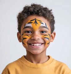 Smiling Boy with Tiger Face Paint Against White Background