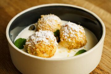 Fried cottage cheese dumplings with vanilla sauce