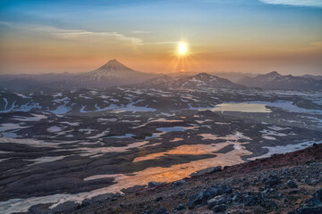 Sunrise from the top of Gorely volcano and view to Vilyuchinsky volcano in Kamchatka Peninsula in Russia.
