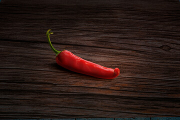 Red chili pepper on wooden background.
