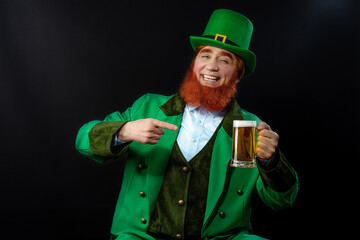 Leprechaun elf on St. Patrick's Day. Cheerful character Irish leprechaun for advertising with a red...