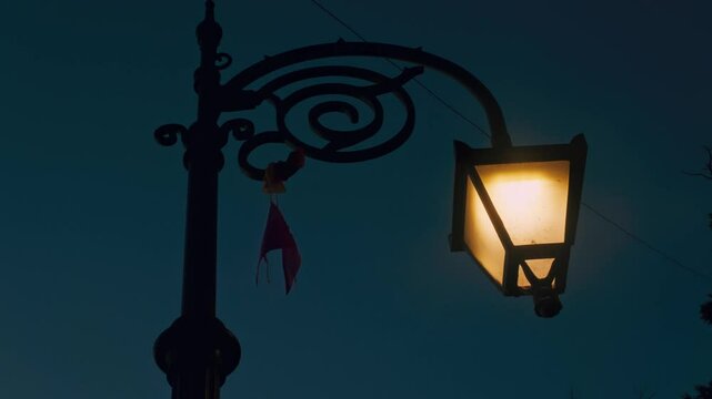 Glowing old British street lamps and small flags waving 4K stock video