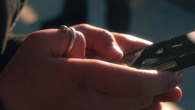 Closeup of a girl's hands typing on mobile phone 4K stock video