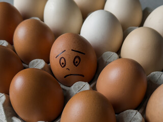 Sad smile drawn on egg