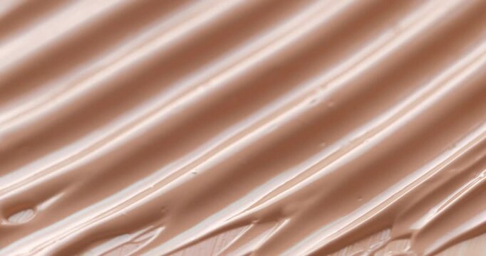 Liquid make up foundation or concealer cosmetic texture close up. Beauty abstract