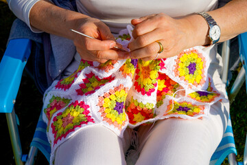 middle-aged woman knitting crochet