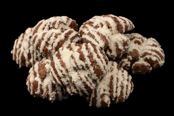 Profiteroles with coconut cream on a black background.