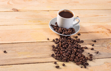 cup coffee and cofee beans on wooden background