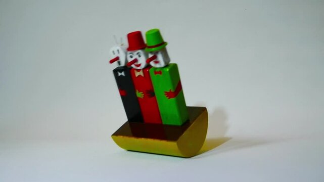 clowns with red noses and hats slowly