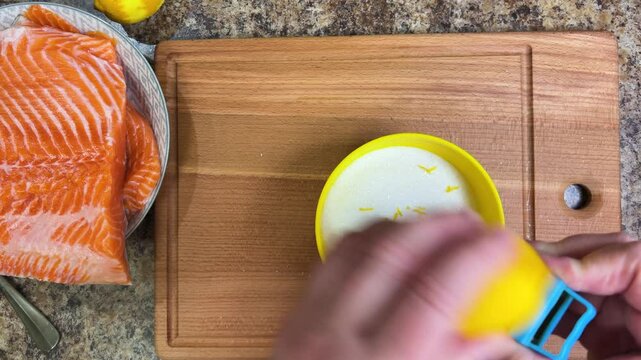the process of salting salmon fish. lemon zest is