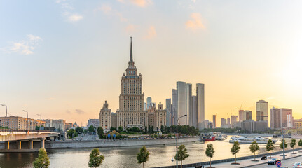Obraz premium High-rise stalinist building near river at summer sunset in Moscow, Russia. Historic name is Hotel Ukraine.
