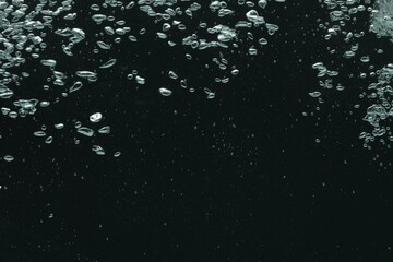 Many water bubbles on black background, closeup