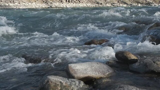  Mountain river running over stones in sunlight 
