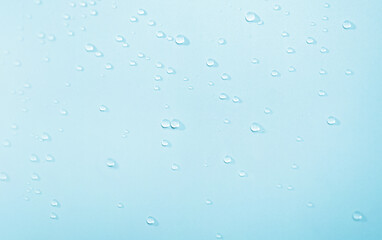 Transparent water droplets, blue water background. transparent surface of clean water with splashes. Favorite sharpness, copy space, text location