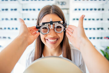 Smiling Woman Using Optical Examination Device During Eye Test Appointment