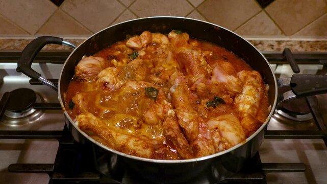 Spicy Indian style chicken curry cooking on the stove.
