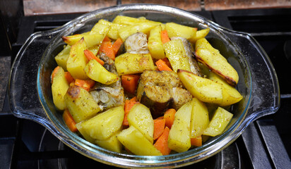 hake fish baked with potatoes and carrots. tasty and healthy food for children and adults. fish and vegetables. proper nutrition