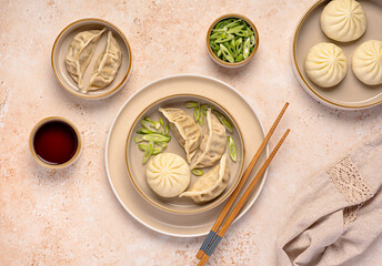 Food photography of steamed duck bao buns and chicken gyoza, spring onion,  soy sauce, Chinese...
