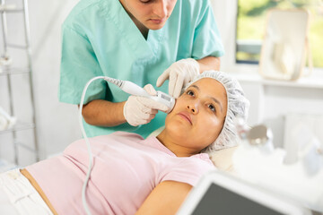 Using device and cold hammer whitening attachment, young specialist expertly performs the...