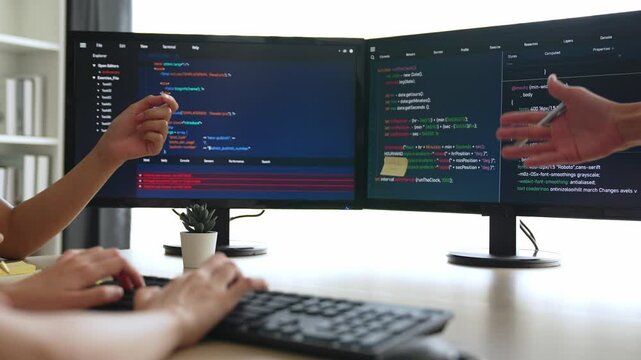 Back end software developer engineer for computer programming working together on debugging writing computing code, solving complex algorithms display on monitor in office. Burgeoning