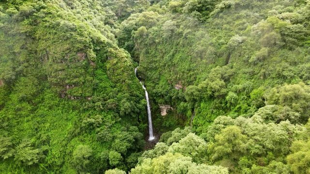 drone traveling out waterfall  mountain