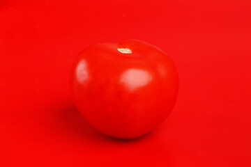 red tomato on red background