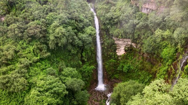 drone traveling out waterfall  mountain