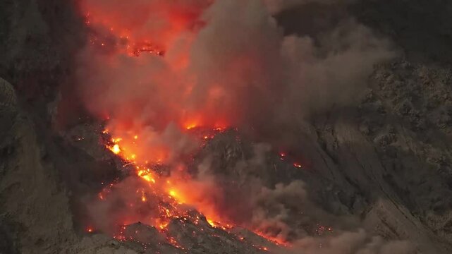 Glowing rockfall of hot lava cascading down the flank of Mount Sinabung volcano, Indonesia.