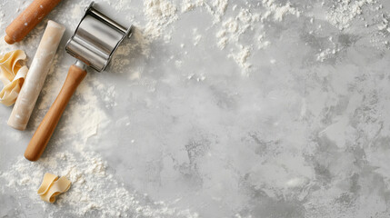 Flat Lay Composition of a Pasta Maker, Rolling Pin, and Scattered Flour on a Clean Gray Surface with Space for Text, Representing Handmade Pasta and Traditional Italian Cooking, Copy Space