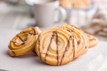 Sweet chocolate cookies on white table.