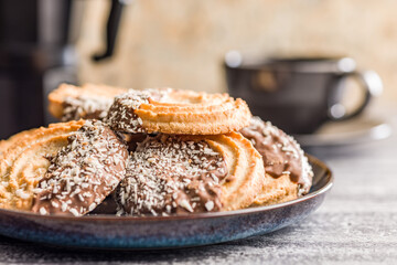 Sweet chocolate cookies on plate on kitchen table.