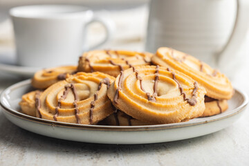 Sweet chocolate cookies on plate on kitchen table.