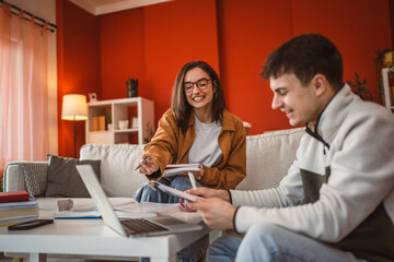 two students man and woman use laptop for prepare exam at home